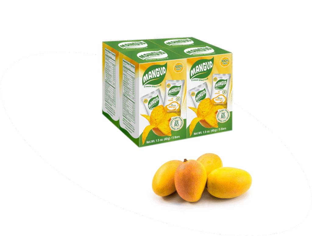 Box of MANGUA freeze-dried mango snacks next to fresh mangoes on a white background.